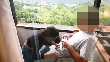 Milf gives blowjob on apartment balcony