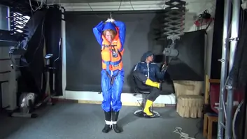 See ronja tied and gagged by stella in shiny nylon rainwear and a life vest