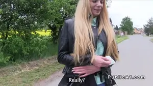 Leaning on cars hood blonde bangs outdoor in public