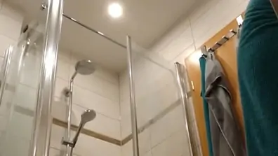 My wife putting on lotion after shower