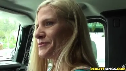 Mature blondie sucks throbbing penis in a car