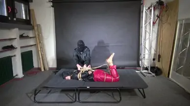 Marie m tightly bound and gagged in shiny nylon rainwear