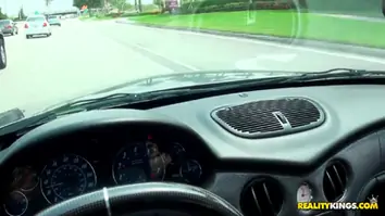 Caprice sucks on a dong while driving