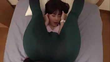 Korean girl taking pictures in bed room with puppy